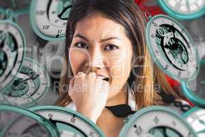 Composite image of businesswoman biting her fist