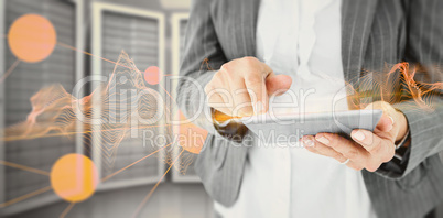 Composite image of  businesswoman using her tablet