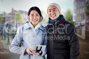 Composite image of cheerful couple against buildings