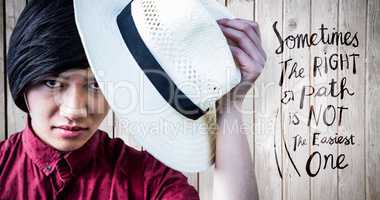 Composite image of hipster with a straw hat