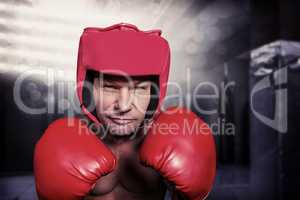 Composite image of portrait of boxer with gloves and headgear