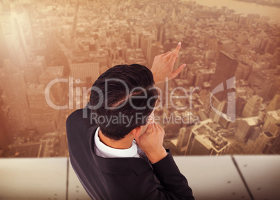 Composite image of thoughtful asian businessman pointing