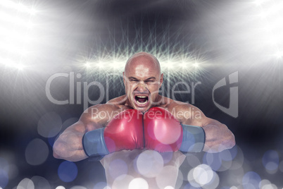 Composite image of aggressive boxer flexing muscles