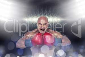 Composite image of aggressive boxer flexing muscles