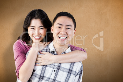 Composite image of smiling man gives girl a piggy back