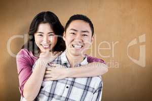 Composite image of smiling man gives girl a piggy back