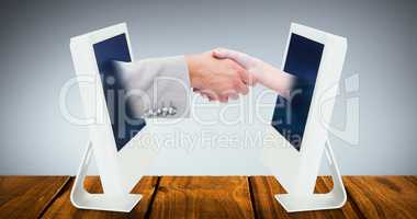Composite image of close up of female and male hand shaking