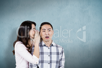 Composite image of woman whispering secret to husband