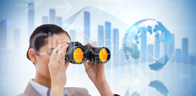 Composite image of brunette businesswoman looking through binocu