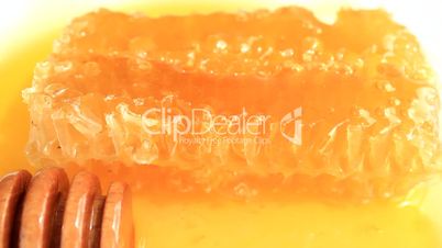 fresh honey with wooden dipper and honeycomb