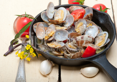 fresh clams on an iron skillet