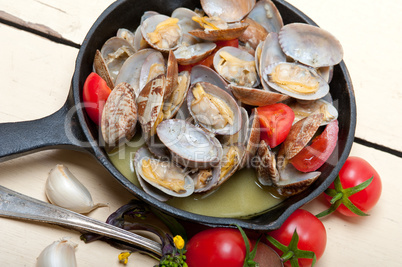 fresh clams on an iron skillet