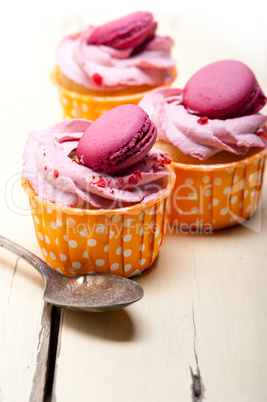 pink berry cream cupcake with macaroon on top