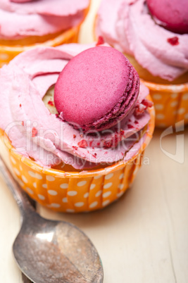 pink berry cream cupcake with macaroon on top