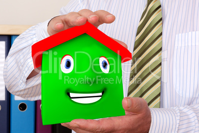 Businessman holding house
