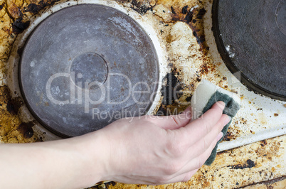 Women hand clean dirty stove