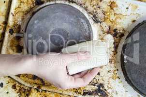 Women hand clean dirty stove