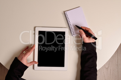 Businesswoman with a tablet and a notebook