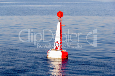 red white moored buoy in blue sea