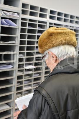 Active ederly man in a post office