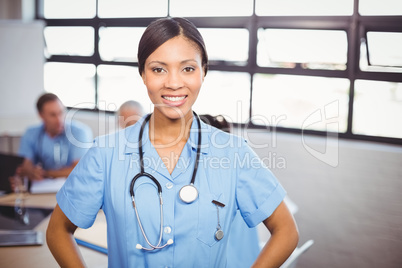 Portrait of happy female doctor smiling in conference room