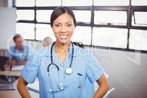 Portrait of happy female doctor smiling in conference room