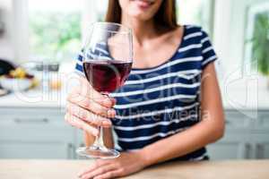 Young woman holding red wine glass