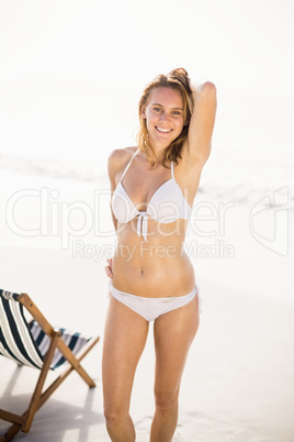 Portrait of pretty woman in bikini standing on the beach