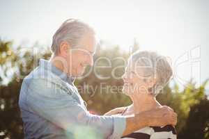 Side view of cheerful senior couple looking at each other