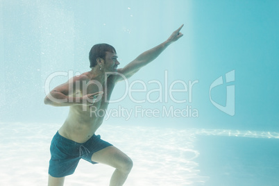 Man gesturing while standing underwater