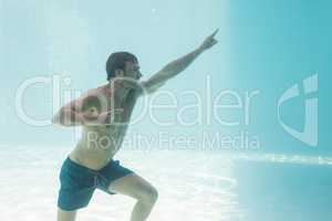 Man gesturing while standing underwater