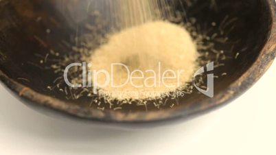Amaranth seeds  pouring into rustic bowl close-up Isolated Superfood