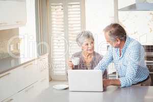 Senior couple interacting in kitchen