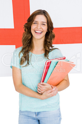 Portrait of young woman holding books