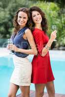 Happy female friends holding champagne flutes