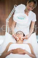 Masseur massaging woman