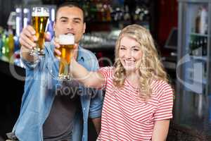 Smilinh couple holding beer