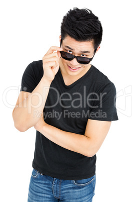 Young man looking over his sunglasses