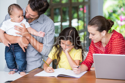 Mother helping daughter with homework