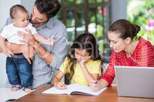 Mother helping daughter with homework