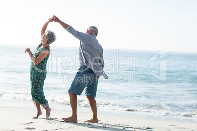 Senior couple dancing at the beach