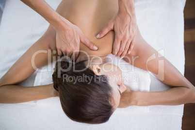 Woman receiving back massage at health spa