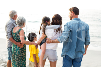 Rear view of a happy family posing at the beach