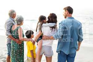 Rear view of a happy family posing at the beach