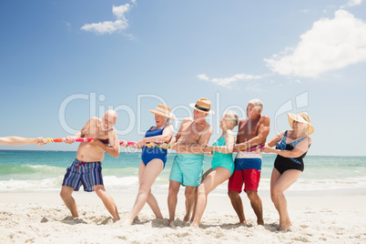 Senior friends playing tug of war