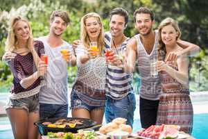 Portrait of friends having juice at outdoors barbecue party