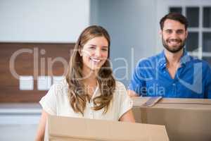 Portrait of couple holding boxes