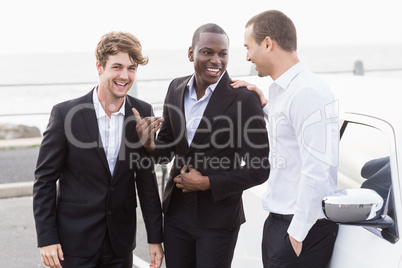 Well dressed people posing next to a limousine Well dressed people posing next to a limousine