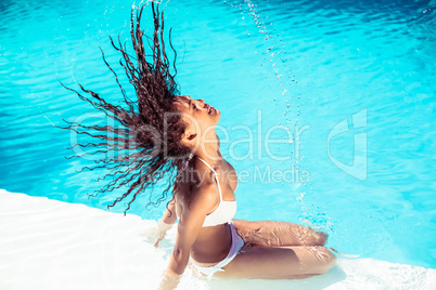 Beautiful woman tossing her wet hair