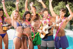 Happy friends enjoying at the swimming pool